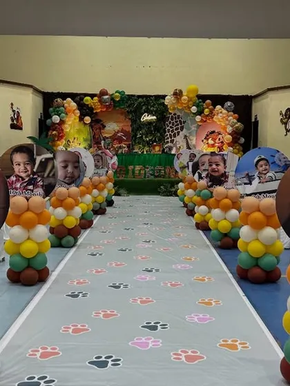 A detailed view of the themed aisle runner with paw prints and personalized photo pillars, making the journey into the party hall a part of the fun.