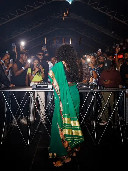 From behind the decks, facing a sea of phones capturing the moment. It's a powerful feeling to share my unique blend of saree-clad DnB with such an engaged audience.
