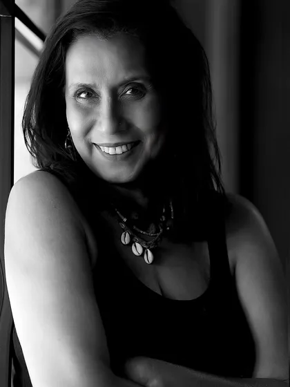 A warm and engaging black and white portrait of Swaroopa Ghosh, showcasing her beautiful smile and expressive eyes.