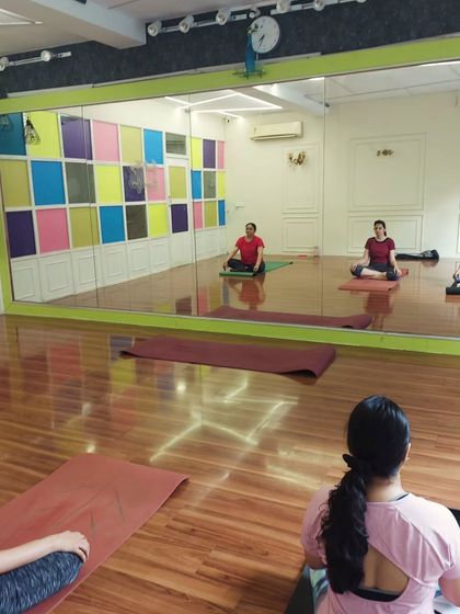 A moment of stillness and focus. Here, students are seated in a comfortable cross-legged position, preparing for pranayama or meditation at the end of our session.