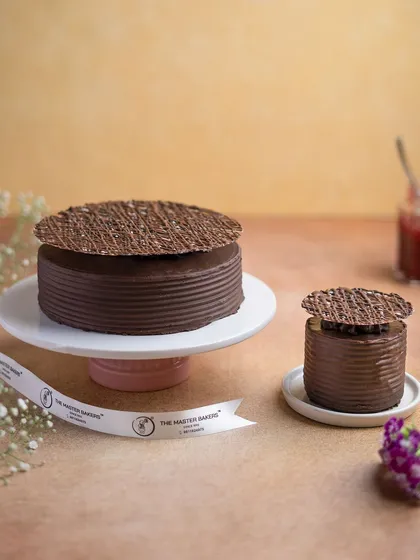 A look at our Chocolate Raspberry cake, available in both a full celebration size and a mini version for a personal treat. Each is finished with a delicate, web-like chocolate disc on top.