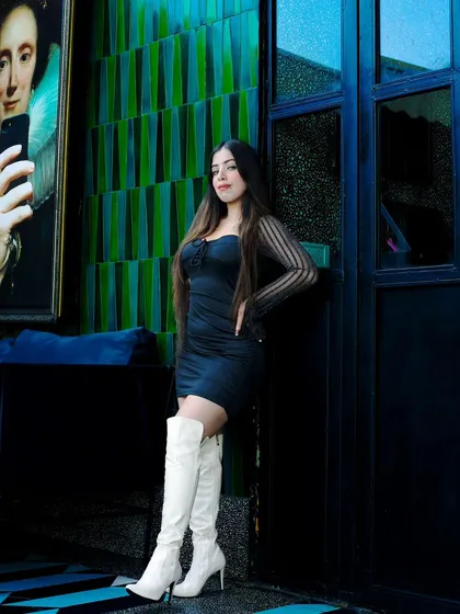 An influencer shoot at a stylish lounge. The goal was to create a chic, moody portrait that matched the location's vibe. The lighting highlights the model's outfit against the dark, artistic background.