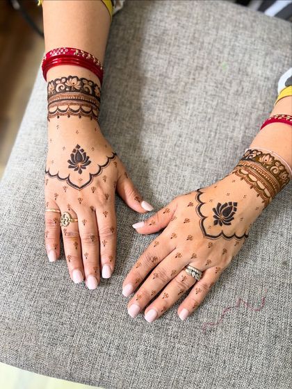 The back of the hands featuring a simple lotus motif, a perfect example of "less is more."