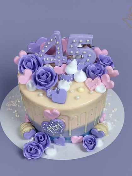 A lovely lavender-themed cake for a 45th birthday. This design is decorated with purple roses, hearts, and a "Mom" plaque, making it a sweet and personal gift.