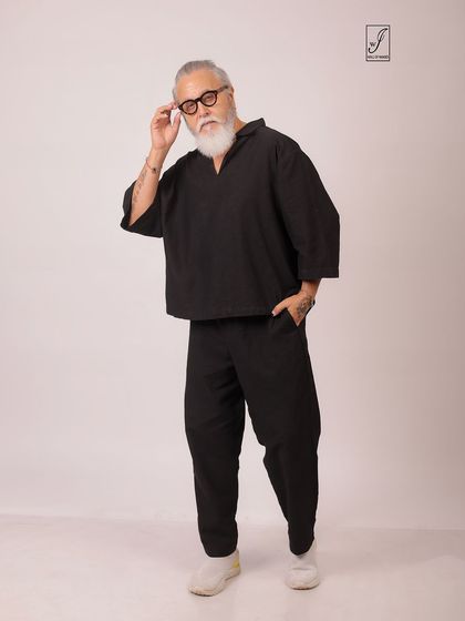 A senior model showcasing a relaxed, minimalist outfit. This portrait highlights personal style and a confident attitude.