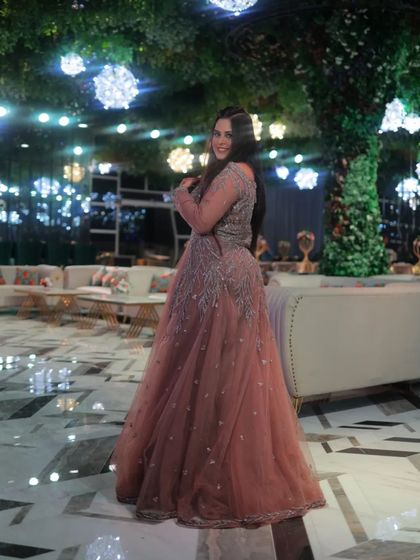 A client looking like a princess in our dusty pink full-flair gown. Perfect for a grand engagement party.