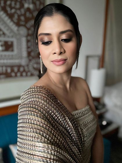 This shot showcases the beautiful contour and highlight that gives the skin a sculpted, radiant finish under evening lights. It's all about that lit-from-within glow.