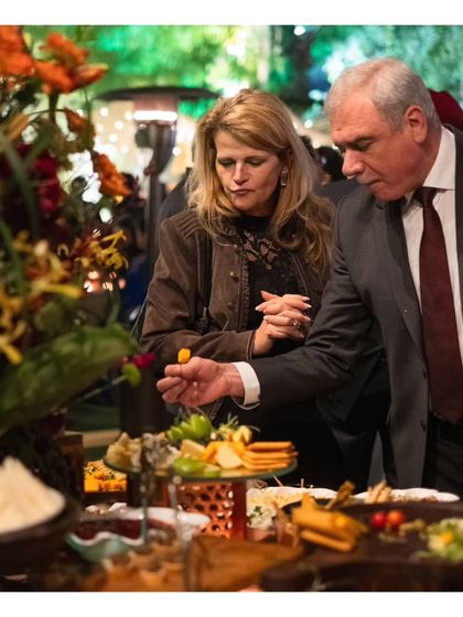 Guests enjoy selecting items from a lavish grazing table. Seeing guests interact with and appreciate the spread is a testament to its appeal and our successful execution.