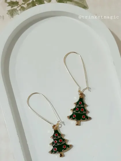 Decorate your ears with these Christmas tree hoop earrings. The detailed enamel tree charm is perfect for any holiday party.