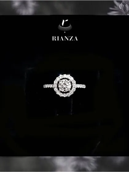 A classic that never fades. This round solitaire diamond ring, set in a halo of smaller diamonds, is a testament to timeless design and is a perfect choice for an engagement or a special anniversary.