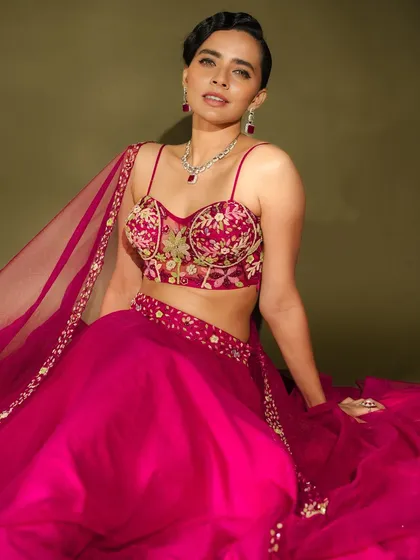 This look showcases a more modern and bold bridal style. For this fashion shoot, I paired a vibrant magenta lehenga with a sleek, contemporary hairstyle and striking makeup. The focus is on a sculpted look with a bold lip and defined eyes, perfect for a bride who wants to make a statement.