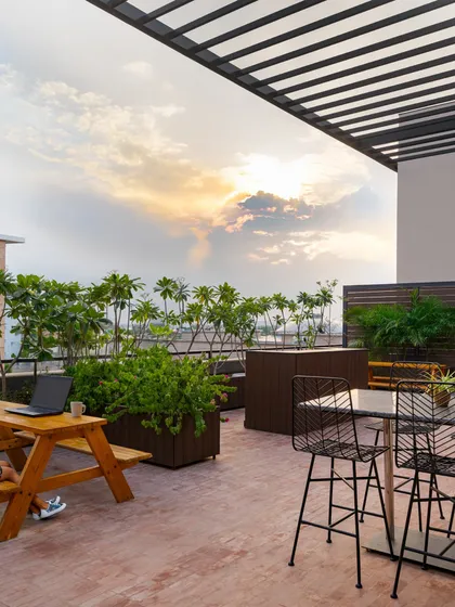 I believe a great workplace includes spaces for rest and rejuvenation. This rooftop terrace at the EaseMyTrip office provides a refreshing breakout area with casual seating and abundant plants. It’s a space designed for employees to recharge, connect, or work in a more relaxed setting, overlooking the city at sunset.
