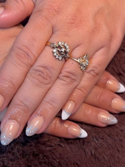 A beautiful combination of a classic white French tip with a silver glitter fade. This is a perfect look for weddings or any festive occasion.