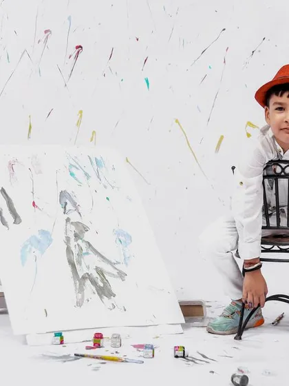 A more serious, artistic pose from our painter-themed session. The little boy contemplates his work, showing a different side of his personality.