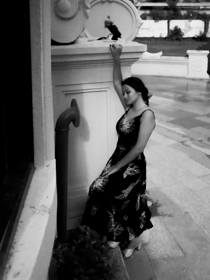 A black and white series exploring different poses against architectural elements. These shots focus on form, light, and the interaction between the subject and her environment.