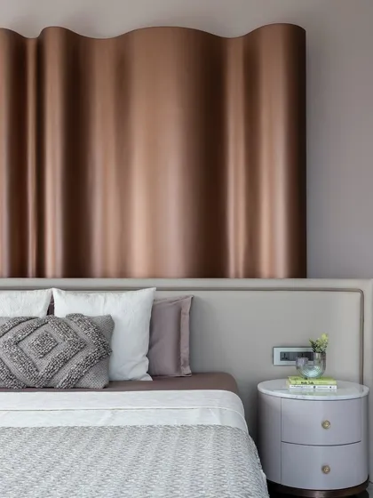 A detail of the wavy, metallic headboard in 'The House of Arcs', which creates a sense of harmony and fluidity.