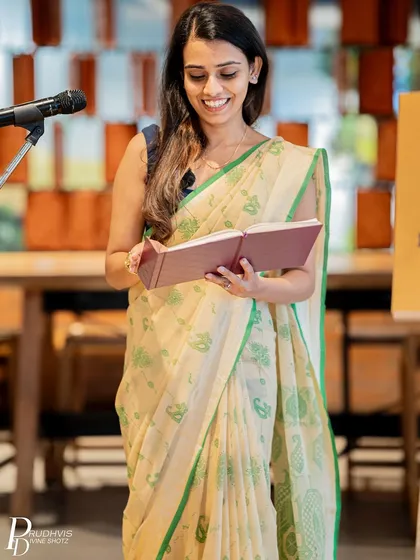 A poet reads from her personal journal, showcasing the courage and vulnerability our welcoming stage inspires in performers.