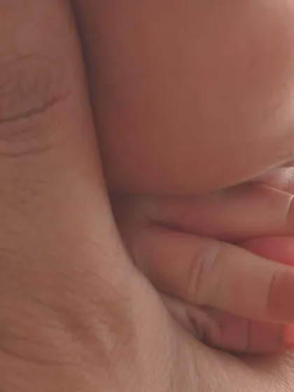 A macro detail shot of a baby's tiny hand wrapped around their parent's finger. It’s a simple but incredibly powerful image that speaks volumes about love and connection.