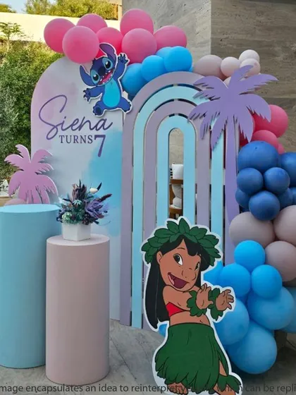 A pastel-colored Lilo & Stitch theme for a 7th birthday. The rainbow-arched backdrops and soft balloon colors create a dreamy, beachy feel.