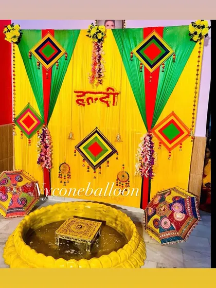 Here is a classic Haldi decor setup I did for a home ceremony. I used bright yellow and green drapes, traditional hangings, and a central low seating area with a decorated chowki inside a large urli, perfect for the rituals.