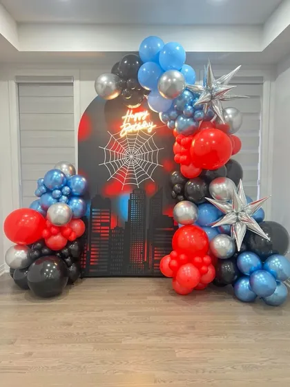 Bringing a superhero to life is always exciting! This Spider-Man themed birthday setup in Chembur featured a dynamic balloon arch in red, blue, black, and silver, complete with a city skyline backdrop, a spiderweb graphic, and a glowing neon sign. It's a modern and action-packed theme that kids absolutely love.