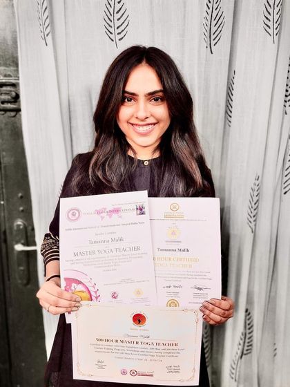 This is the beautiful result of dedication and hard work. A student proudly holding her Master Yoga Teacher certificates after completing her training with us.