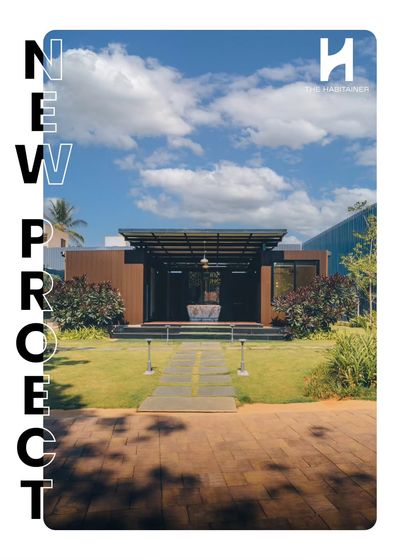Announcing our new twin container office project. This head-on shot shows the building's strong symmetry and inviting entrance, set in a manicured lawn. It's a perfect example of a compact yet impactful workspace.