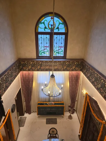 A view into a grand family home I designed in Mangalore, showcasing a double-height space with a traditional chandelier and stained-glass window. This project was a humbling opportunity to blend classic architectural elements with modern living.