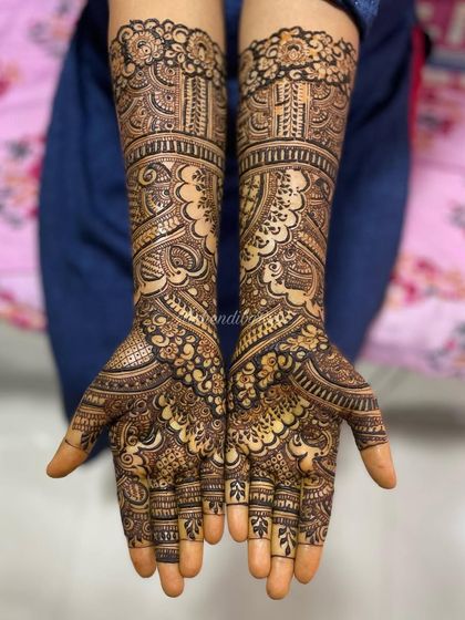 This design is a beautiful example of classic Indian bridal henna. It features paisleys, intricate floral bands, and delicate leaf patterns for a timeless and elegant look.