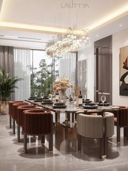 A view of one of our elegantly styled dining rooms. We focus on combining statement lighting, comfortable seating, and high-quality materials like marble and brass to create spaces that are perfect for both everyday meals and special occasions.