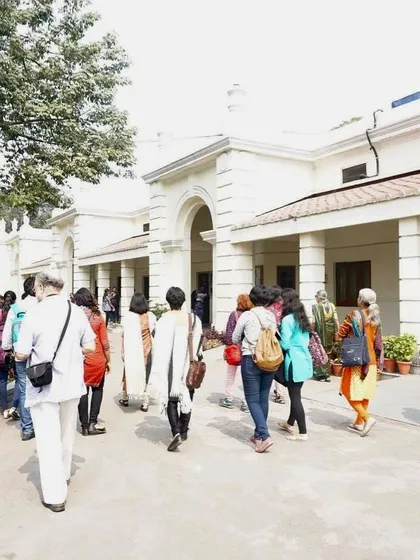 A group walks through the historic Alipore House campus of Indraprastha College. The college moved to this location, the former residence of the British Commissioner in Chief, in 1938.