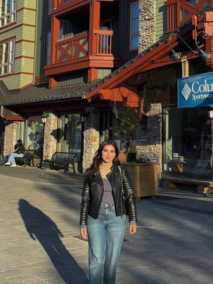 A daytime shot in Blue Mountain Village, showing a casual outfit against the European-style architecture.