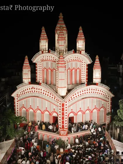 The beauty of Durga Puja is in the details. This is a low-altitude shot of a pandal in Prayagraj, designed with classic red and white Bengali patterns. I make sure to capture the energy of the crowd gathered for darshan.