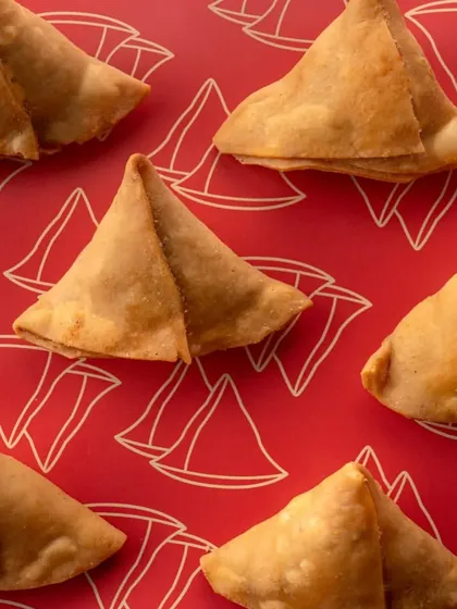 We handled the complete rebranding for A1 Samosas, including this vibrant product shot. The bold red background with custom illustrations makes the classic samosas look modern and exciting.