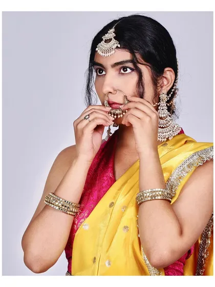 A detailed close-up focusing on the traditional nath (nose ring) and other jewellery. This shot is essential for showcasing accessories and the intricate details of bridal makeup and hairstyling.