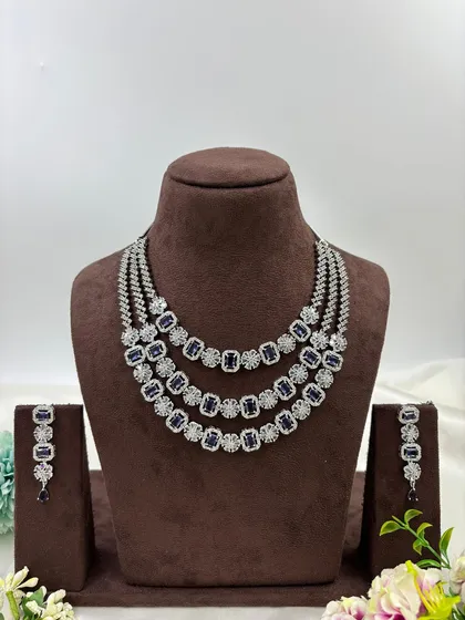 The three-layer AD necklace with blue stones.