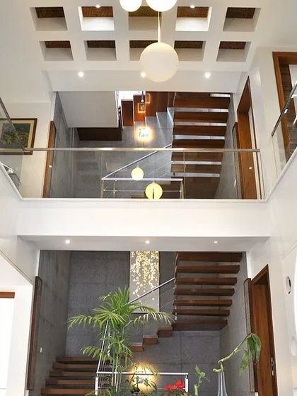 A view from the upper level looking down into a double-height atrium. This design feature creates a sense of vertical space and visual connection between the different floors of the home.
