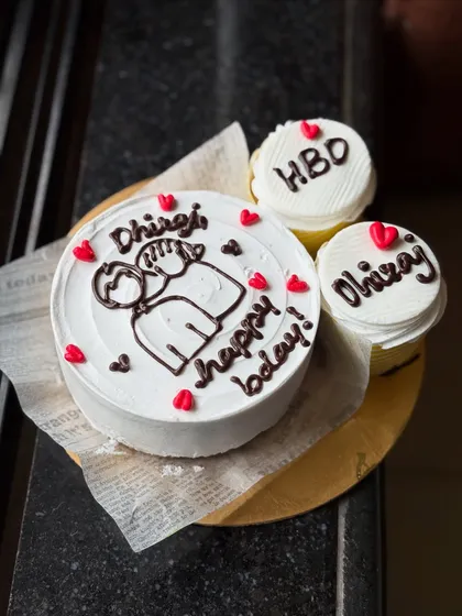 A lovely personalized birthday set for Dhiraj. The bento cake features a cute couple illustration, and the two cupcakes are customized with "HBD" and his name.