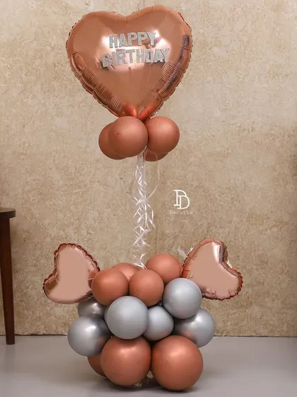 A simple and elegant balloon bouquet in rose gold and silver. This makes for a perfect gift or a standalone decorative piece for a small, intimate celebration.