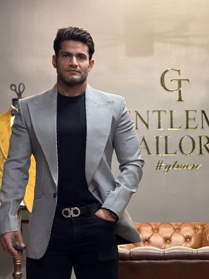 A closer view of the grey patterned blazer, showing the intricate fabric and the confident fit.