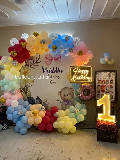 Another angle of the teddy bear first birthday setup, showing the placement of the light-up number and photo frame.