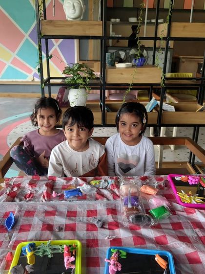 Three kids ready to get creative at a clay modeling workshop. Our events are a great way to spend a fun and productive weekend with the family.