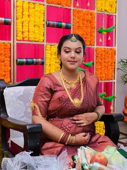 Another beautiful shot of this mom-to-be. The traditional makeup look, complete with a bindi and gold jewelry, is perfect for a classic baby shower ceremony.