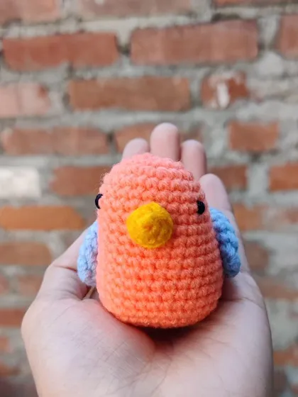 A front-facing view of the small crochet sparrow, highlighting its cute face.