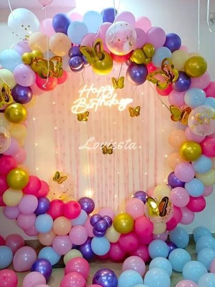 A multi-colored pastel balloon ring with butterfly accents. This vibrant and cheerful setup is perfect for a fun and dreamy birthday party.