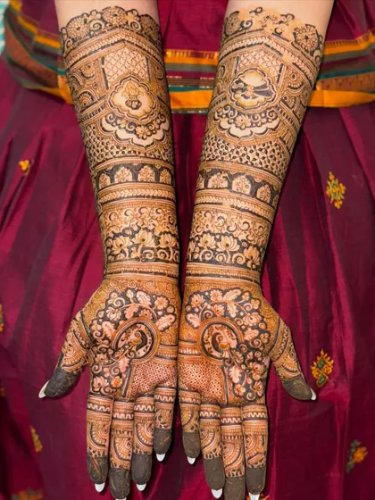 This full-arm bridal mehendi showcases a variety of patterns, from florals to paisleys. The dark, consistent application ensures a beautiful stain and a design that looks stunning from every angle.