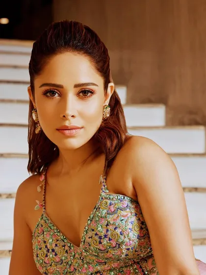 This pastel pink lehenga with intricate floral embroidery is a beautiful choice for a daytime event. I styled this look on Nushrratt Bharuccha for a soft, romantic, and elegant vibe.