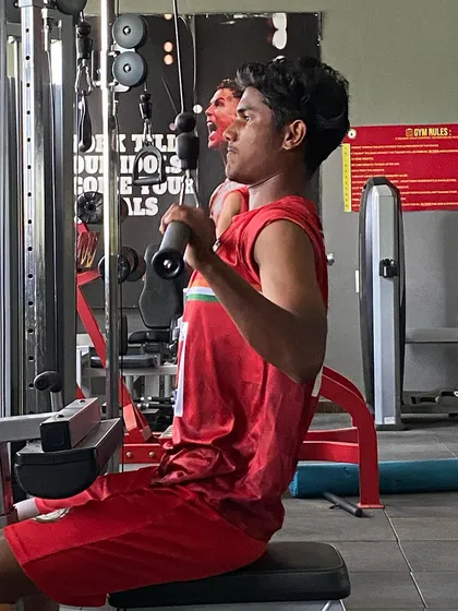 A player works on his back muscles using the lat pulldown machine. Our gym sessions are tailored to build football-specific strength.