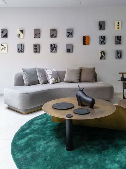 The full installation of abstract painted blocks in the 'House of the Rising Sun' project, arranged as a gallery wall above a modern sofa.