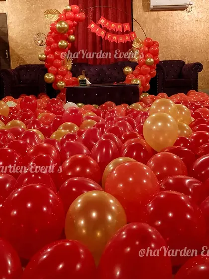 A room filled with red and gold balloons for the ultimate romantic surprise. I can turn any room into a sea of balloons for your loved one.